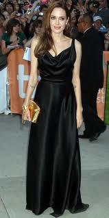 Angelina Jolie Wears Louis Vuitton Gold Clutch Cuffed To Her Wrist
