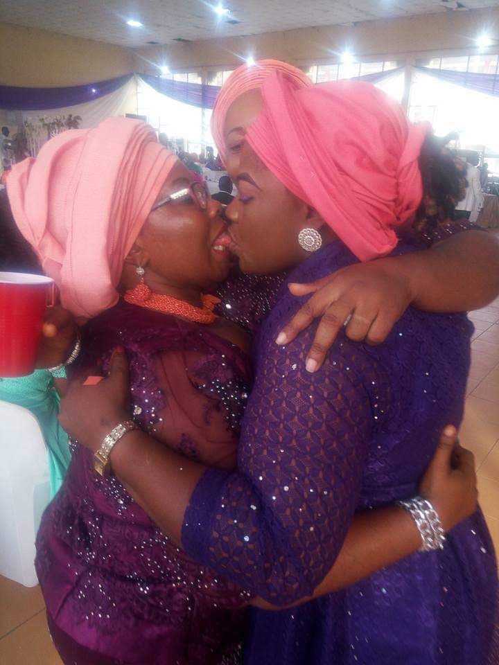 Two Nigerian Women Kissing At A Wedding Ceremony. 